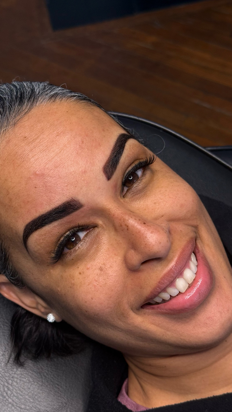Natural, balanced permanent makeup brow results on a client